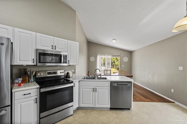 8187 Lode Star Ave, Pensacola, FL 32514 - kitchen with stainless steel appliances, a sink, lofted ceiling, a peninsula, and white cabinets