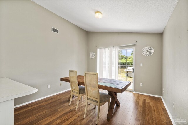 8187 Lode Star Ave, Pensacola, FL 32514 - dining area with hardwood / wood-style floors, baseboards, and vaulted ceiling