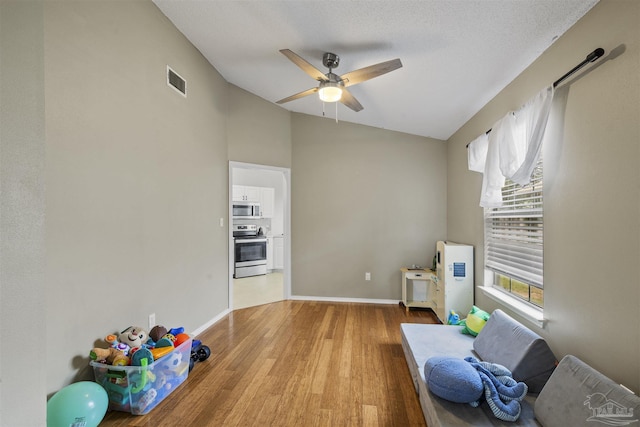 8187 Lode Star Ave, Pensacola, FL 32514 - living area with ceiling fan, light wood-type flooring, healthy amount of natural light, vaulted ceiling, and baseboards
