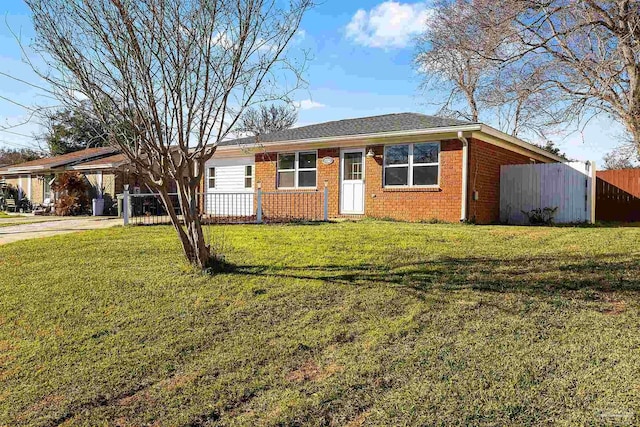 single story home with fence, a front lawn, an attached carport, and brick siding