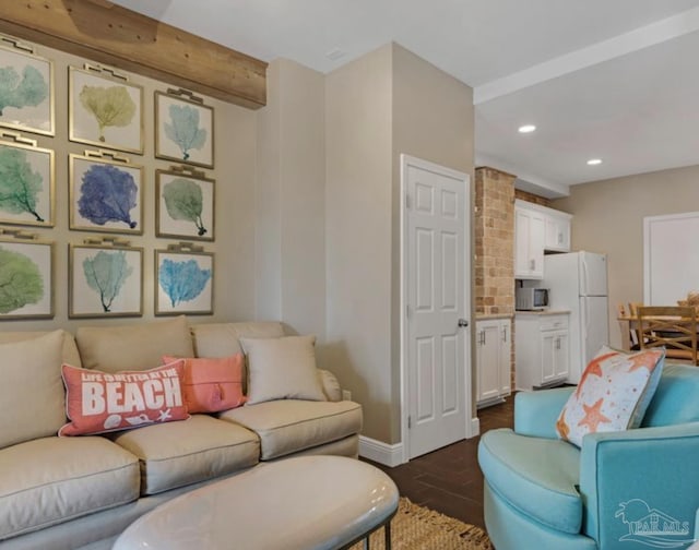 living room featuring beamed ceiling and dark hardwood / wood-style floors