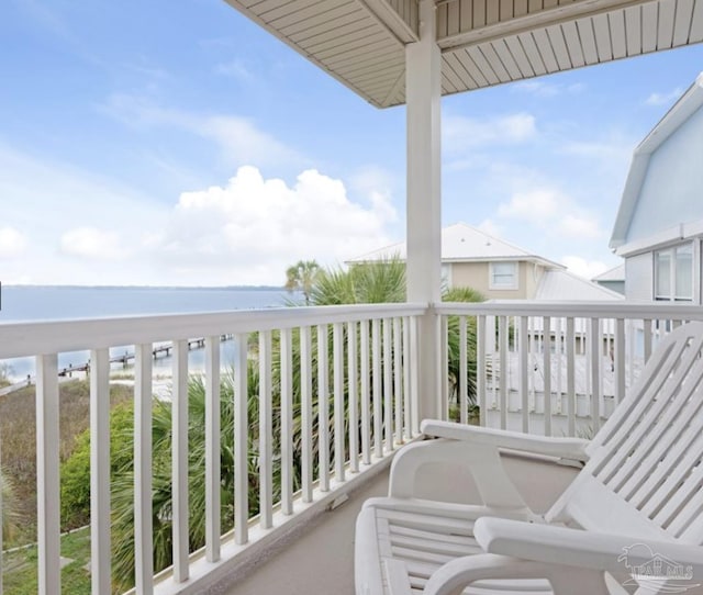 balcony with a view of the beach and a water view