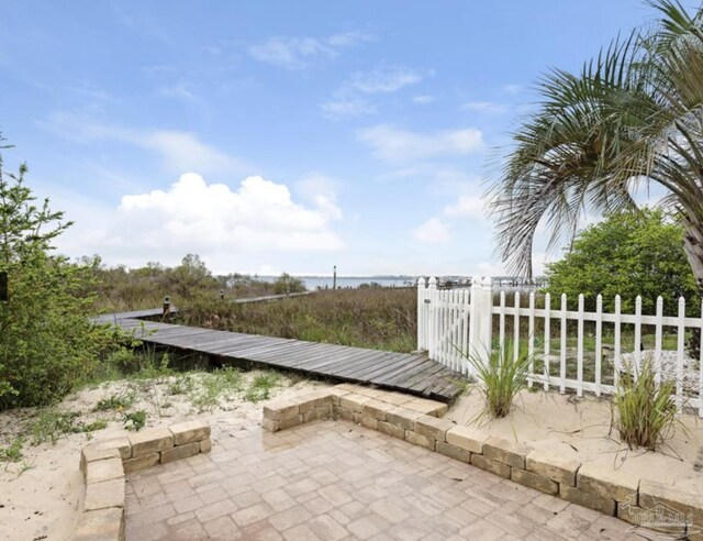 view of patio with a water view