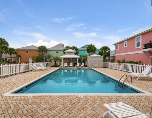 view of pool featuring cooling unit and a patio area