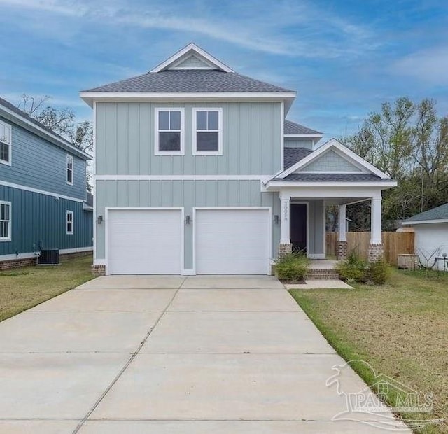 view of front of home featuring central AC unit, a garage, and a front lawn