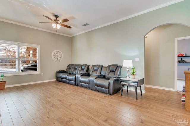 living room with ornamental molding, ceiling fan, and light hardwood / wood-style floors