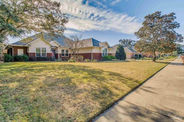 single story home featuring a front lawn