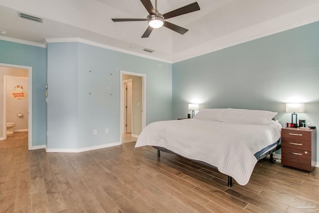 bedroom with hardwood / wood-style floors, ensuite bathroom, ceiling fan, and ornamental molding