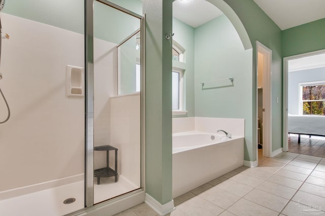 bathroom with tile patterned flooring and independent shower and bath