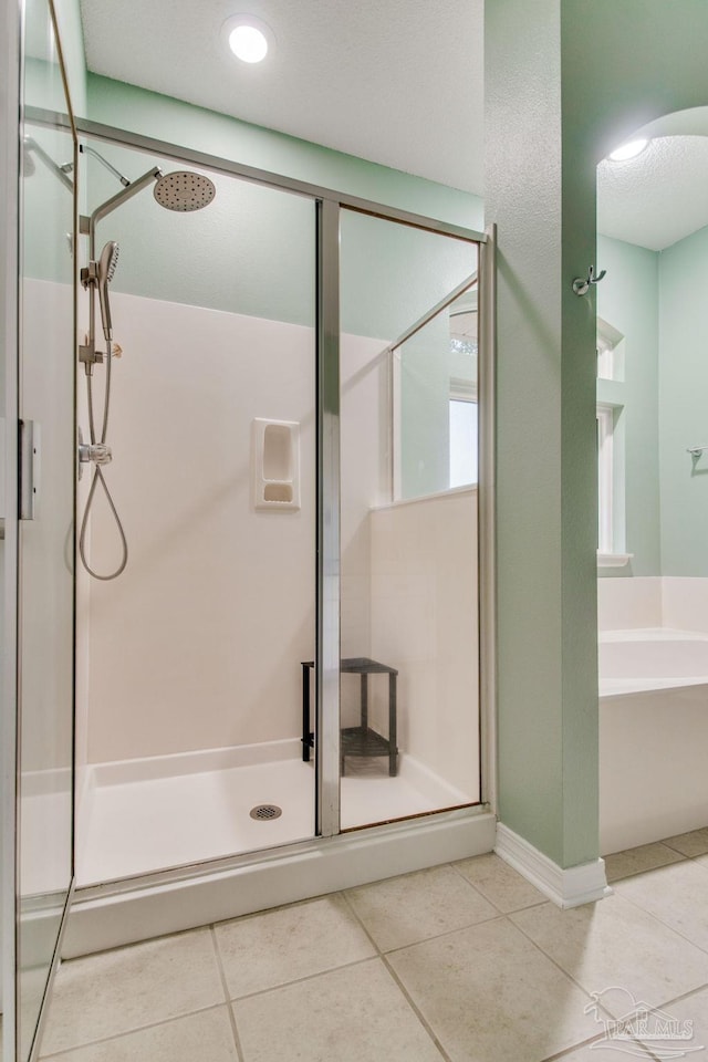 bathroom with tile patterned flooring and plus walk in shower