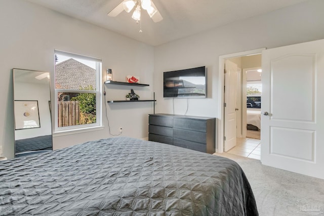 bedroom featuring ceiling fan and light colored carpet