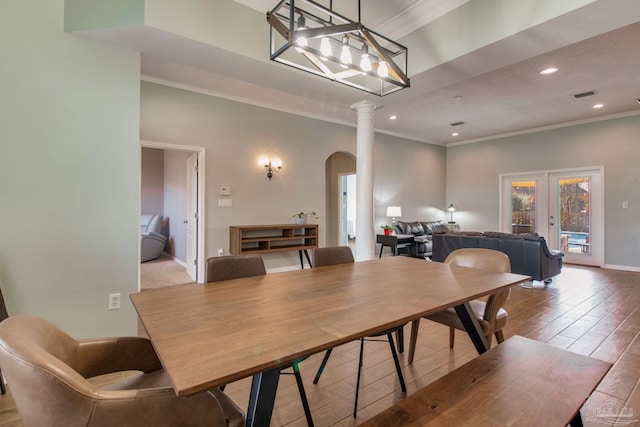 dining room with ornamental molding, french doors, and ornate columns