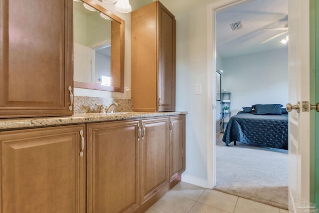 bathroom featuring tile patterned flooring, ceiling fan, and vanity