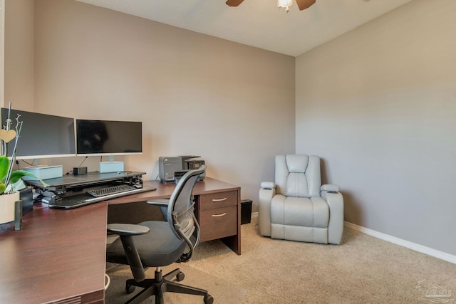 carpeted office space featuring ceiling fan