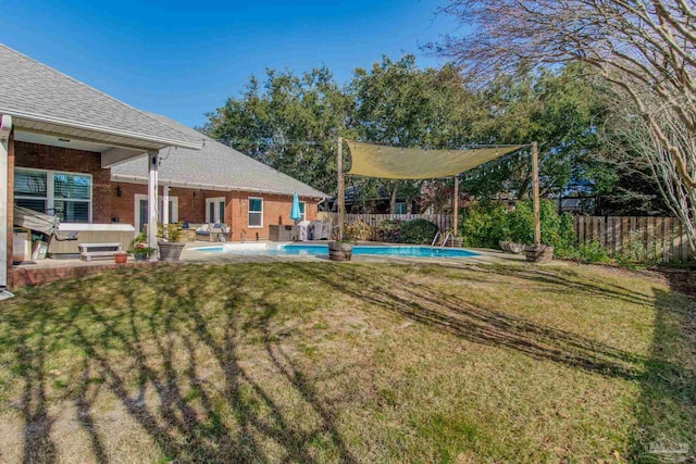 view of yard featuring a pool with hot tub and a patio