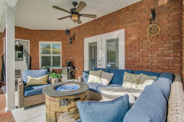 view of patio with an outdoor living space with a fire pit and ceiling fan