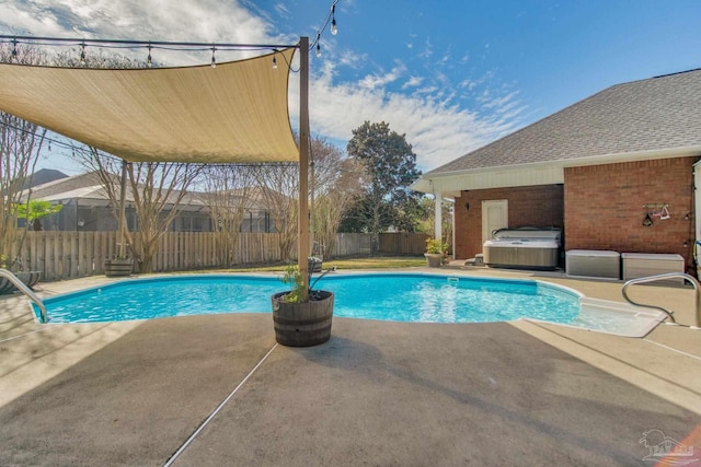 view of swimming pool with a patio area and a hot tub