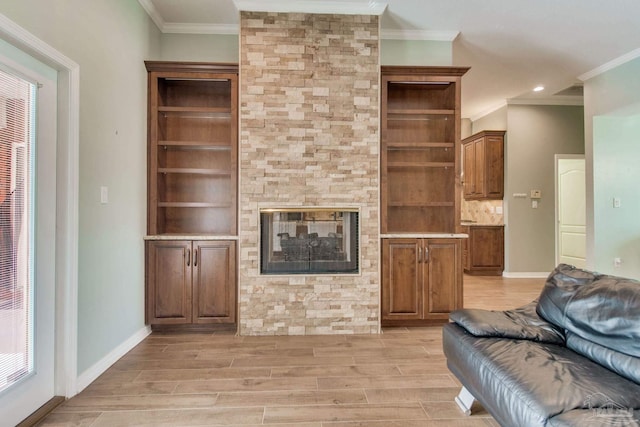 unfurnished living room with a fireplace, light wood-type flooring, and ornamental molding