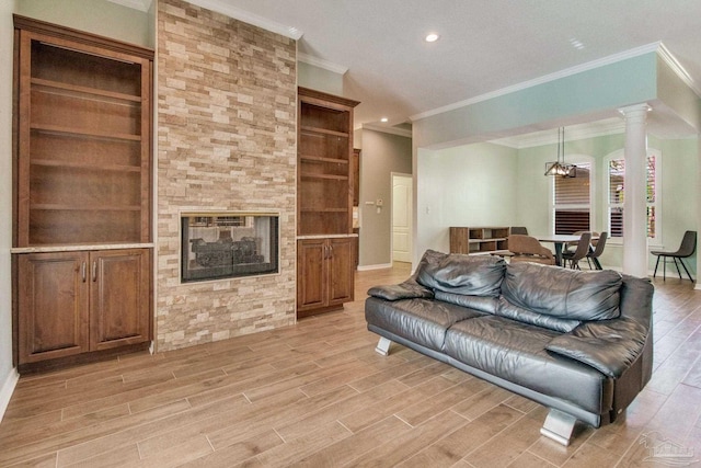 living room featuring a multi sided fireplace, a chandelier, ornamental molding, and light hardwood / wood-style floors