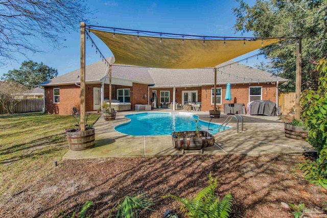 view of swimming pool with a yard, a grill, and a patio area