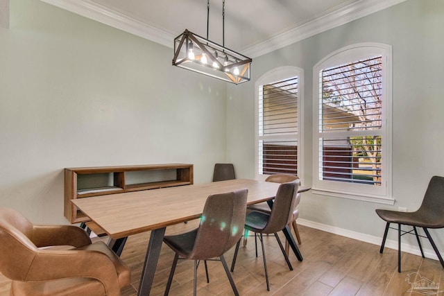 dining area with ornamental molding and hardwood / wood-style floors