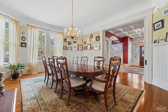 dining area featuring an inviting chandelier, plenty of natural light, hardwood / wood-style floors, and coffered ceiling