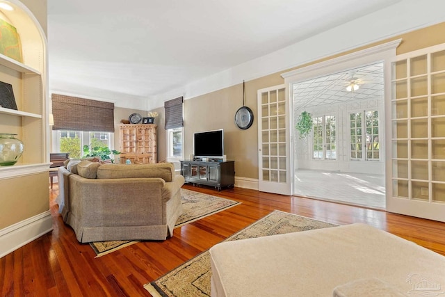 living room with hardwood / wood-style flooring, french doors, and ceiling fan