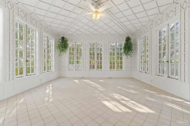 unfurnished sunroom featuring ceiling fan