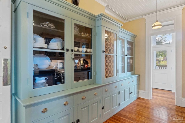 interior space with ornamental molding and light hardwood / wood-style floors