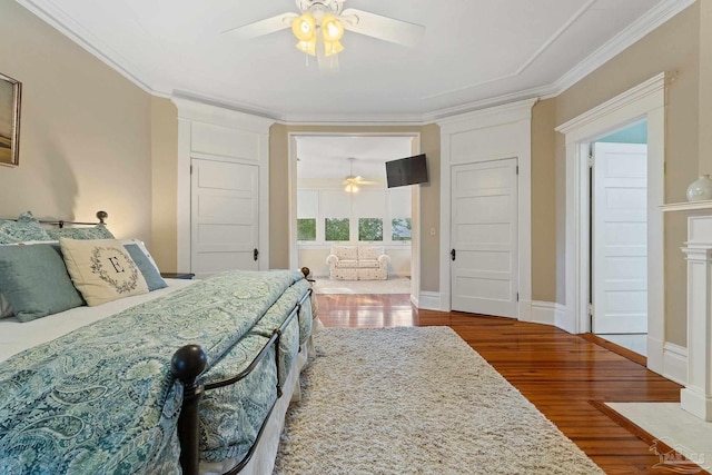 bedroom with crown molding, ceiling fan, and wood-type flooring