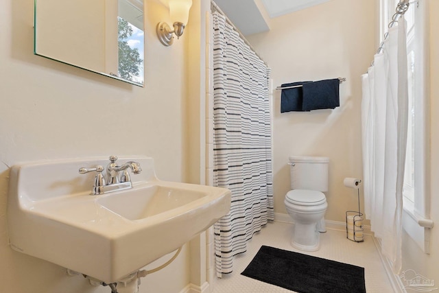 bathroom with sink, tile patterned flooring, and toilet