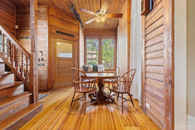 dining area featuring ceiling fan, light hardwood / wood-style floors, vaulted ceiling, and wooden ceiling