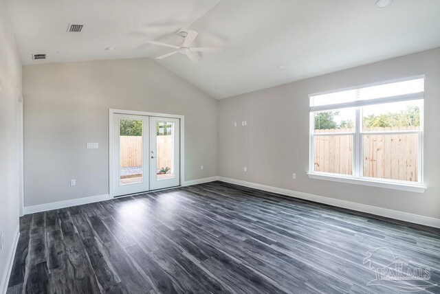 unfurnished room with dark hardwood / wood-style flooring, ceiling fan, french doors, and vaulted ceiling