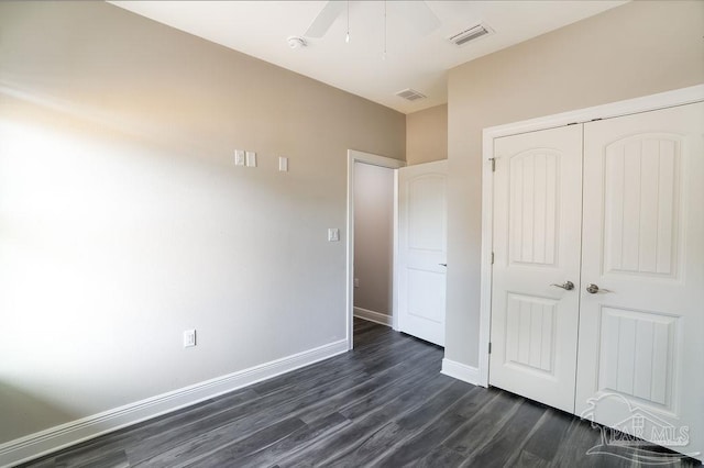 unfurnished bedroom featuring dark hardwood / wood-style flooring, a closet, and ceiling fan