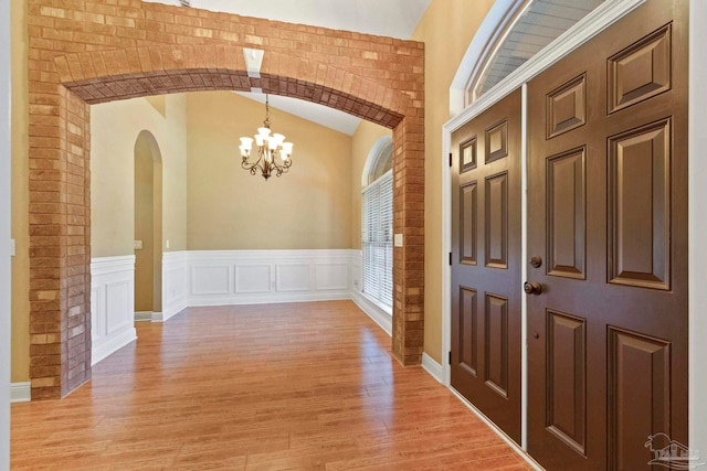 interior space featuring light hardwood / wood-style floors and an inviting chandelier