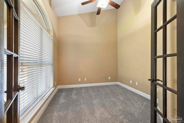 carpeted spare room with vaulted ceiling and ceiling fan