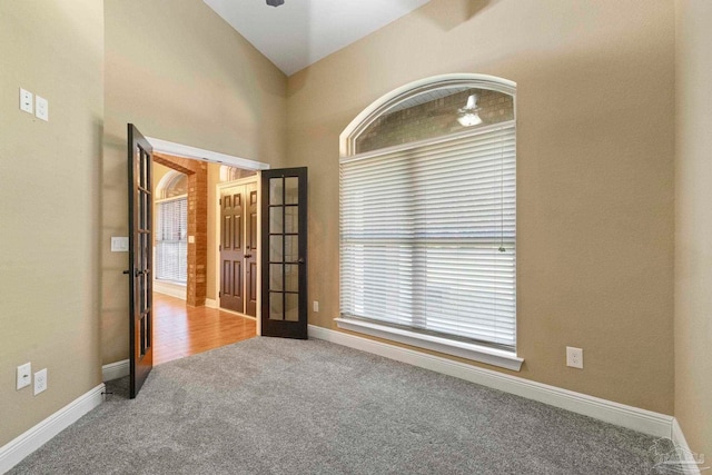 empty room featuring carpet floors and french doors