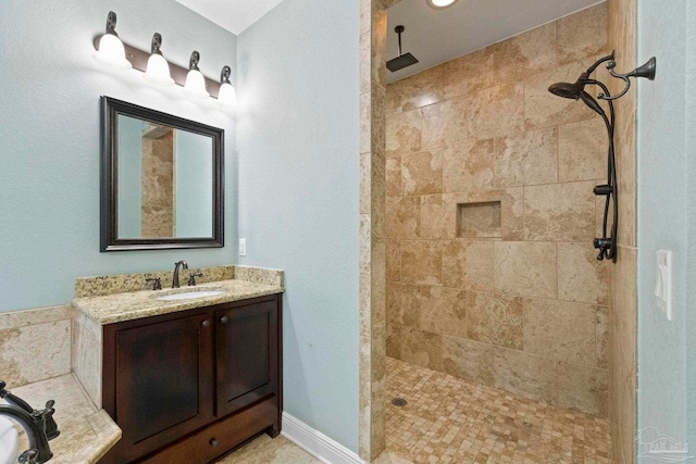 bathroom featuring vanity and tiled shower