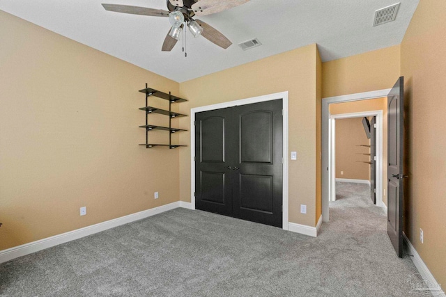 unfurnished bedroom with ceiling fan and light colored carpet