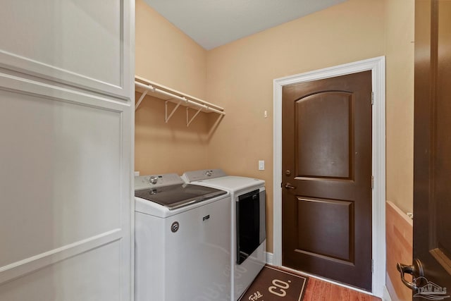 laundry area featuring hardwood / wood-style floors and washer and dryer