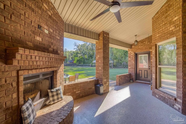 view of patio / terrace with ceiling fan and an outdoor brick fireplace