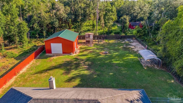 view of yard featuring a garage and an outbuilding