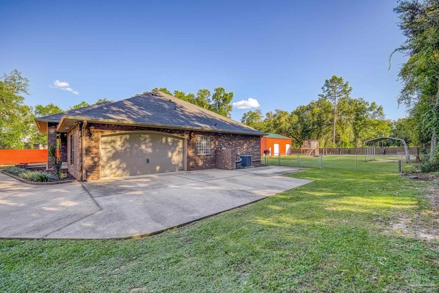 view of side of property with a garage and a lawn