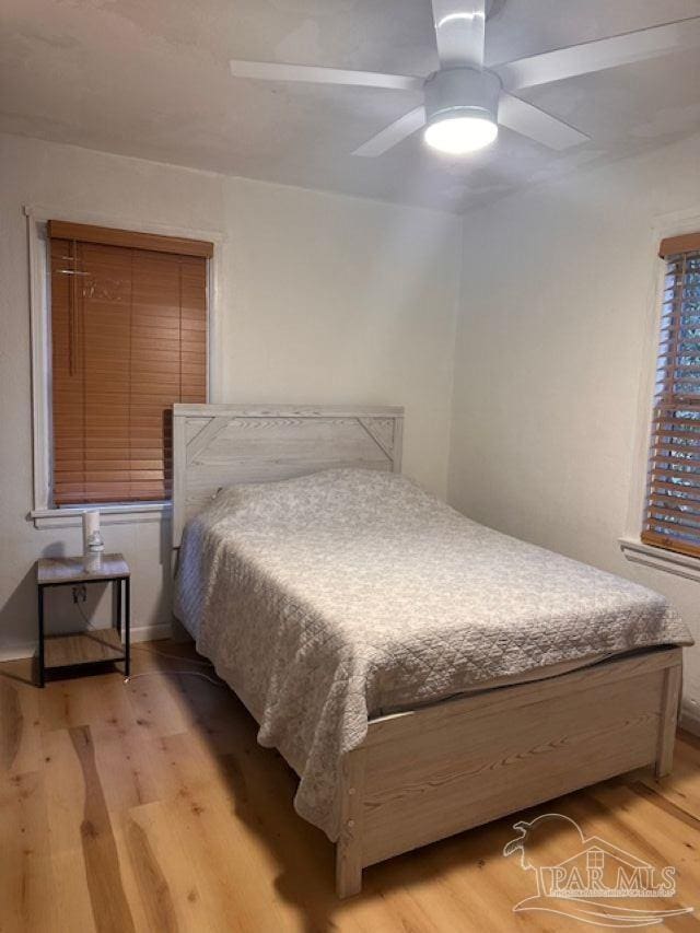 bedroom with ceiling fan and light hardwood / wood-style flooring