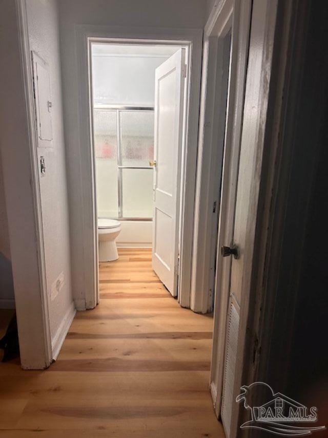 hallway with light hardwood / wood-style floors