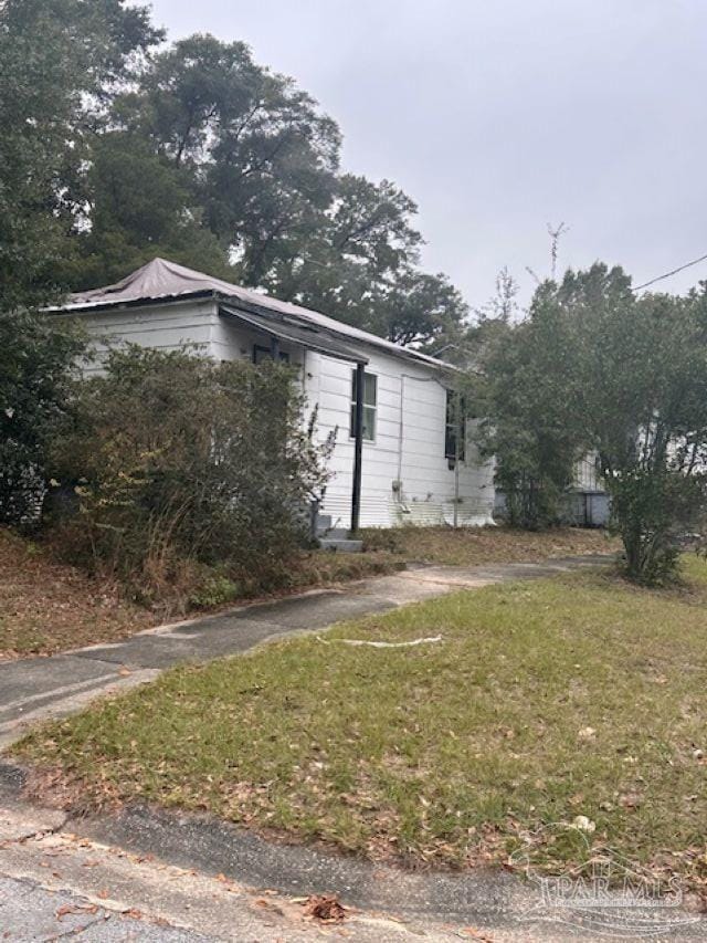 view of home's exterior with a lawn