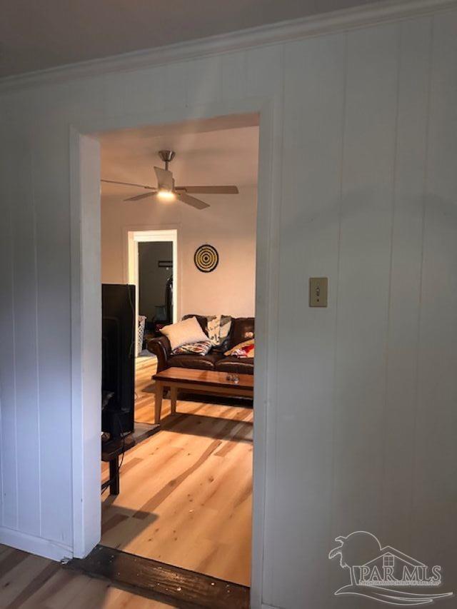 interior space with wood-type flooring and ornamental molding