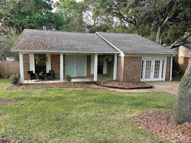 ranch-style home featuring french doors, brick siding, roof with shingles, and a porch