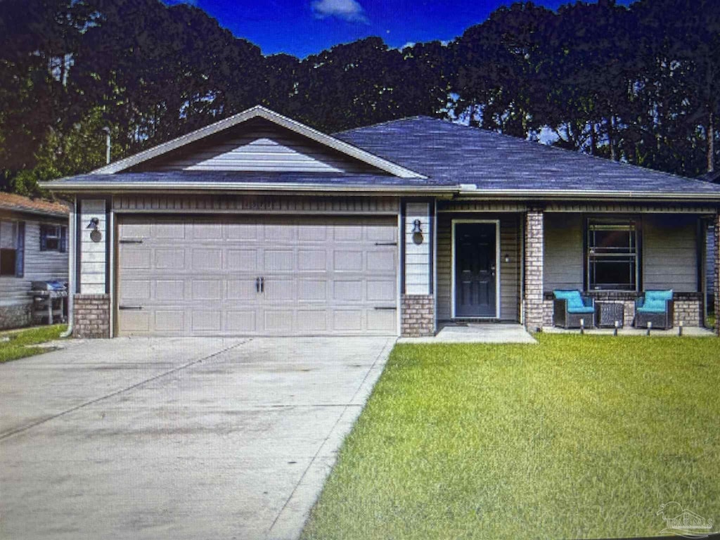 1871 Esplanade St, Navarre, FL 32566 - single story home with a garage, a porch, a front yard, concrete driveway, and brick siding