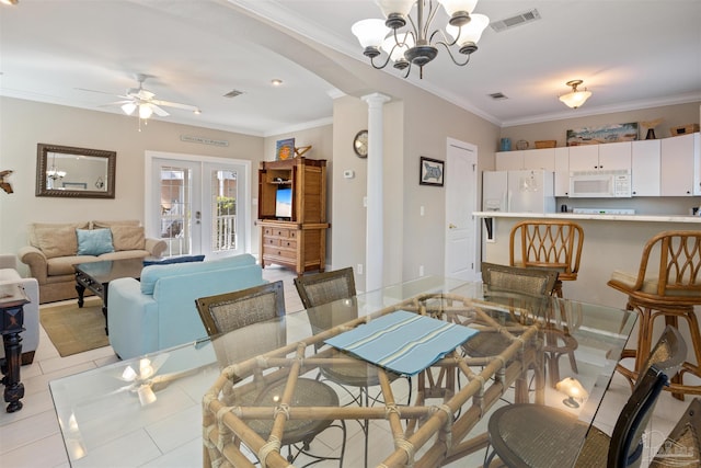 tiled dining area featuring ornate columns, ceiling fan with notable chandelier, crown molding, and french doors